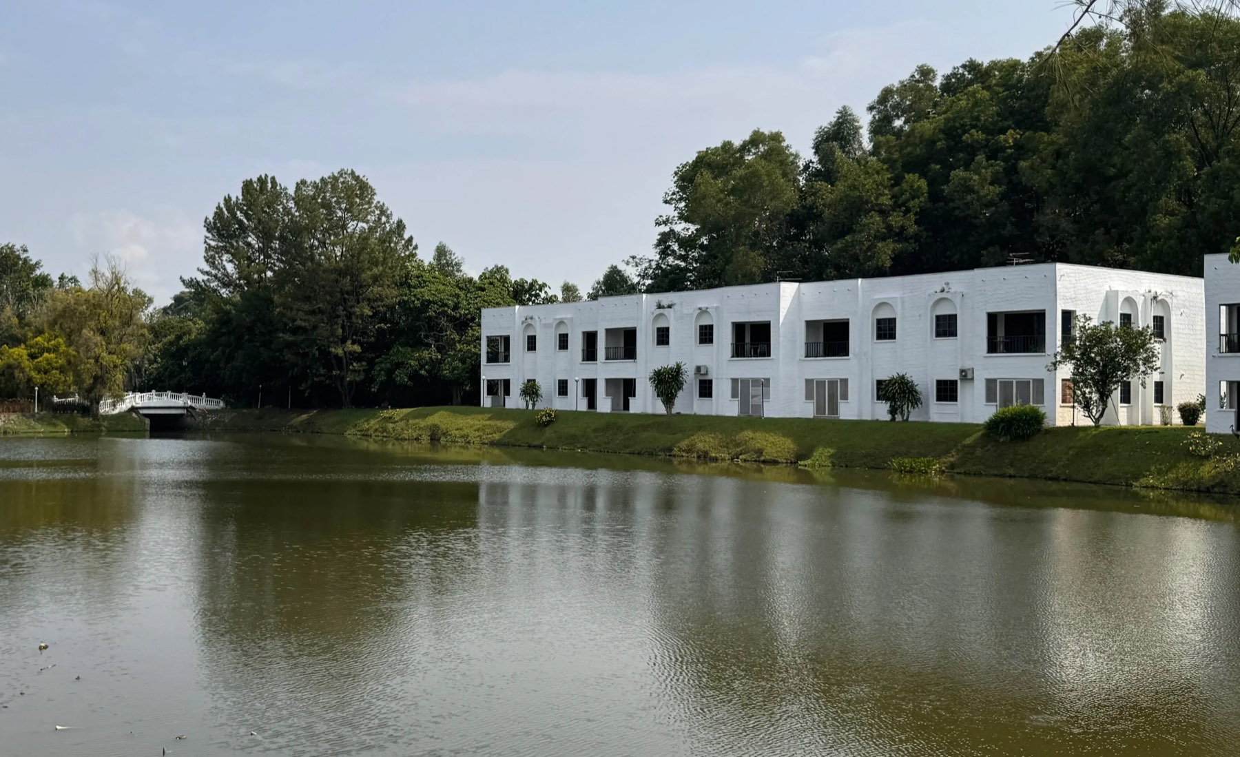 Country Villa's white lakeside villa blocks and arched bridge reflected in the lake, Kajang, Selangor
